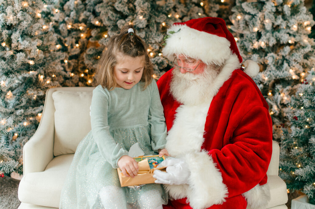 Santa giving a present to the little girl